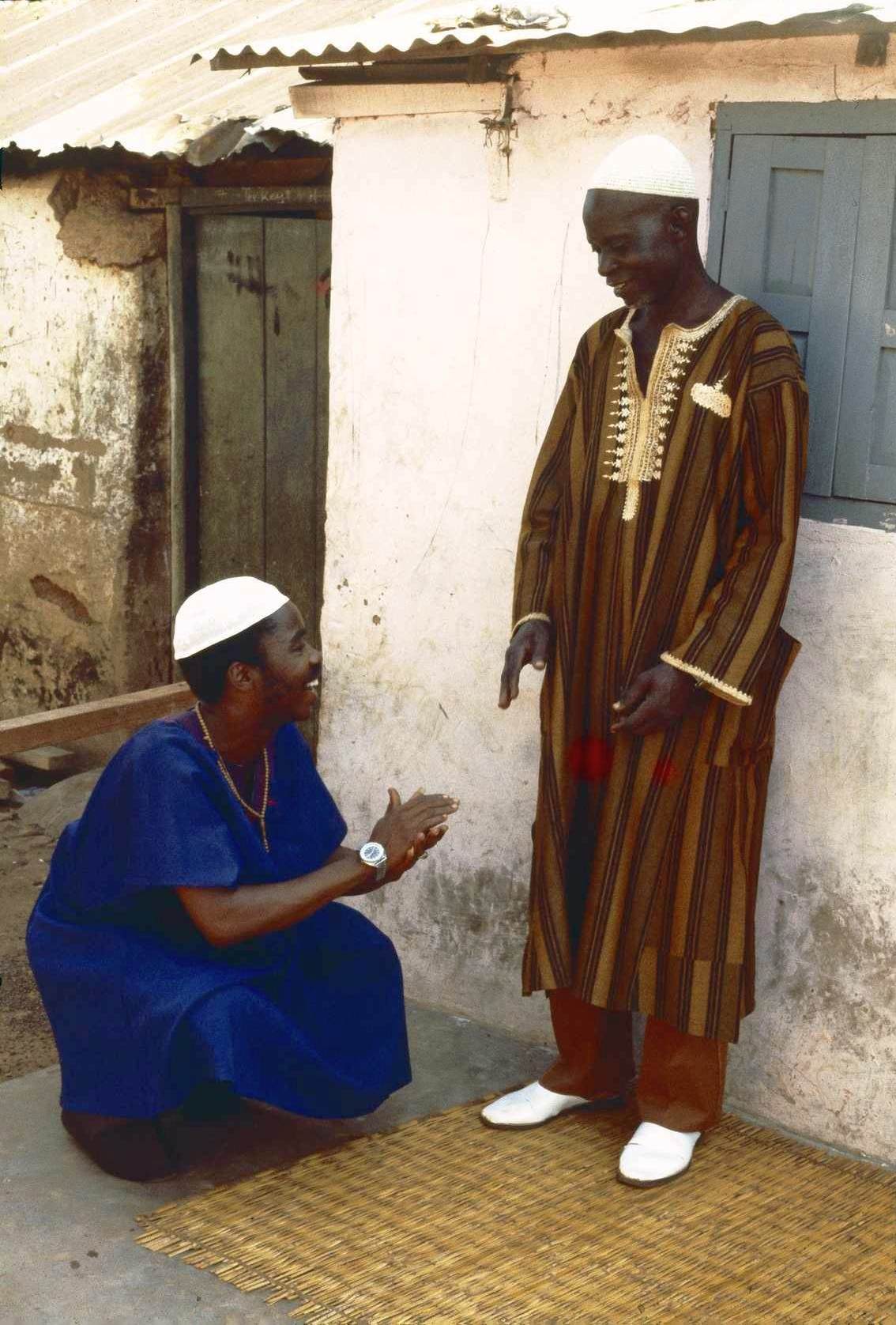 Squatting to greet an elder: Ibrahim Abdulai and Mustapha Muhammad, two of the authors of A Drummer's Testament